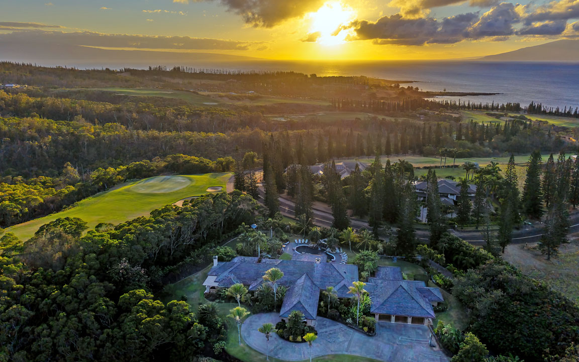 Plantation Estates home in Kapalua with pool and golf course frontage at sunset
